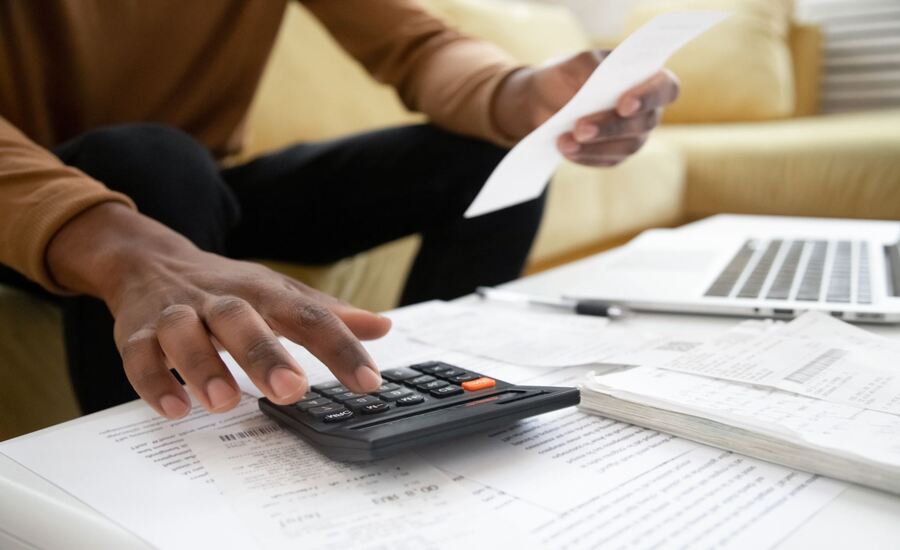 A man with a calculator checks his medical expenses after a car accident