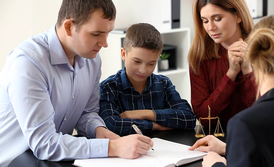 A family with a boy at the lawyer's office