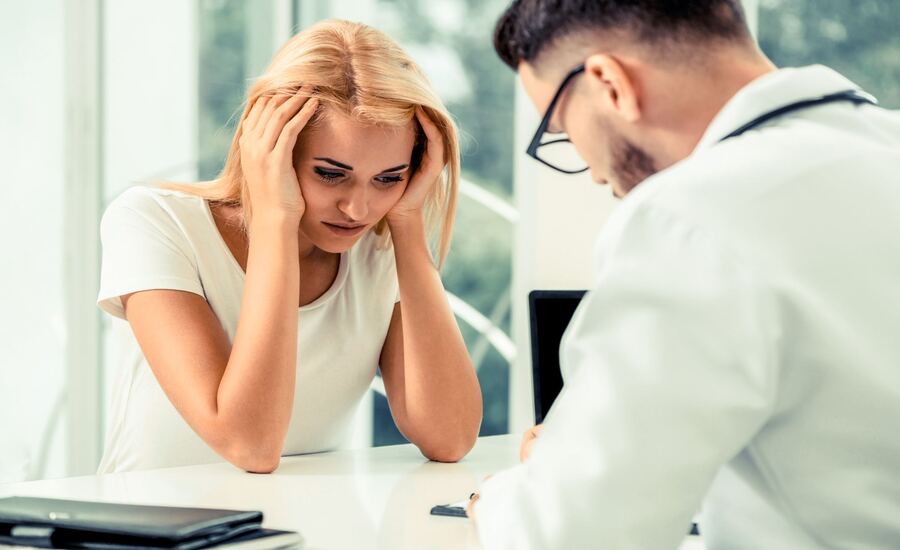 A worried woman at the doctor's office