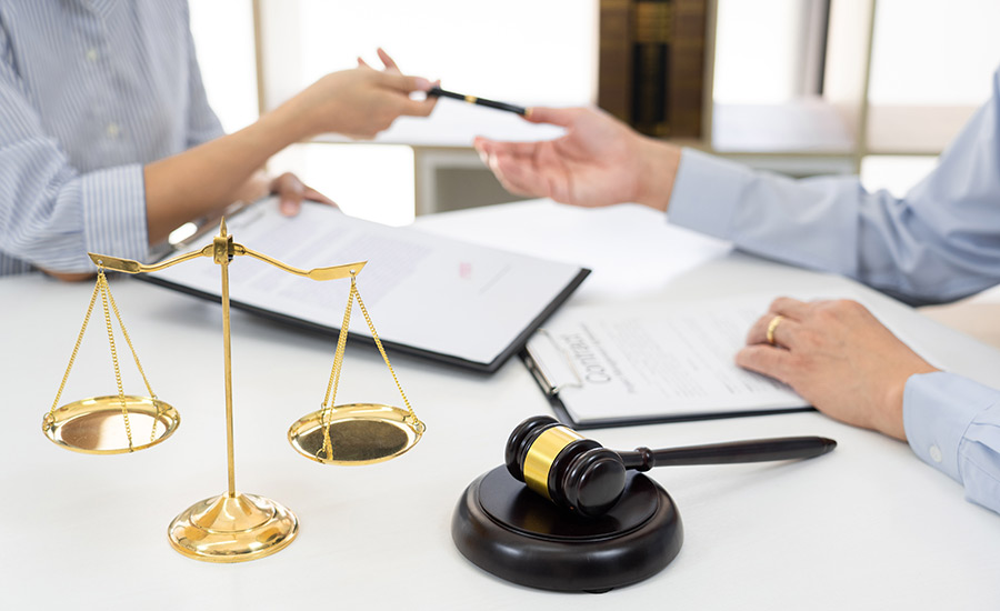 A lawyer helps a client to fill a petition to remove conditions