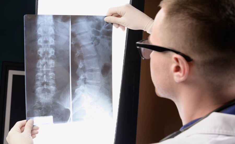 A doctor examining X-rays of a patient