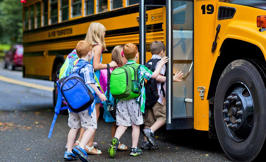 Children getting on a school bus