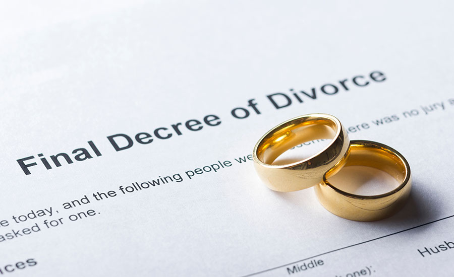 Wedding rings on a divorce decree document