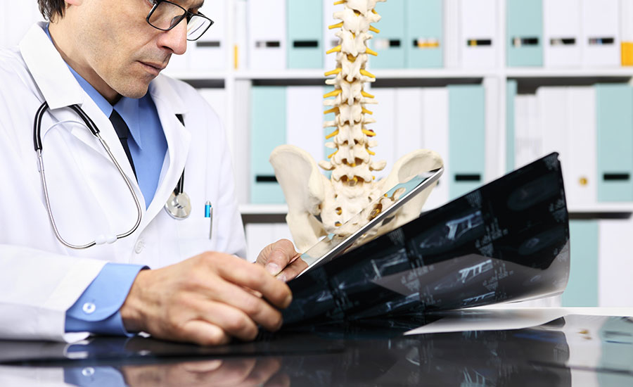 A doctor looking at x-rays of a patient