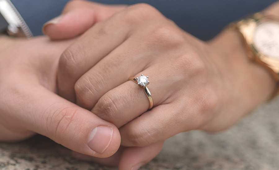 A woman's hand with an engagement ring