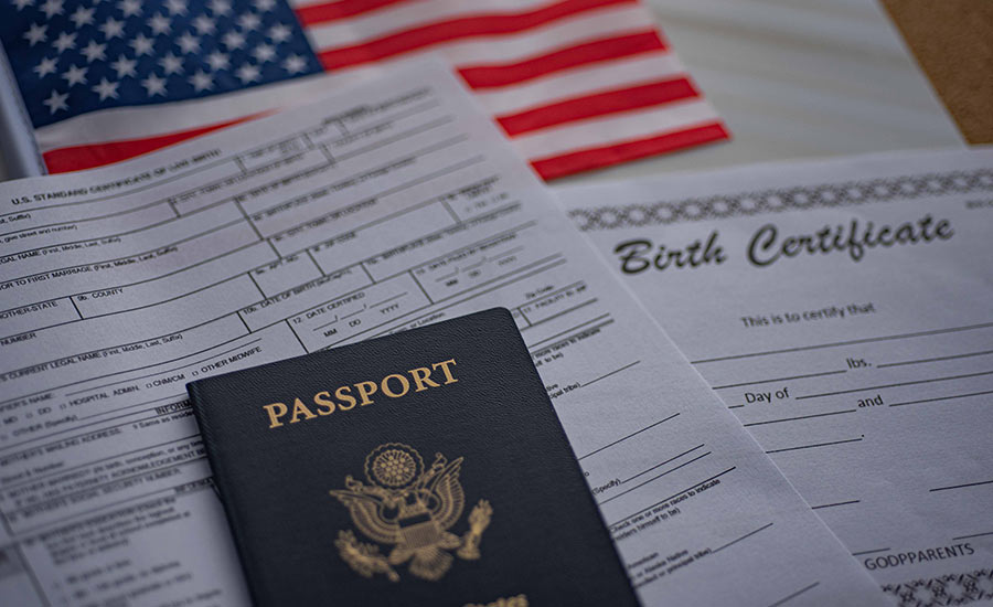A birth certificate, a passport and the US flag​