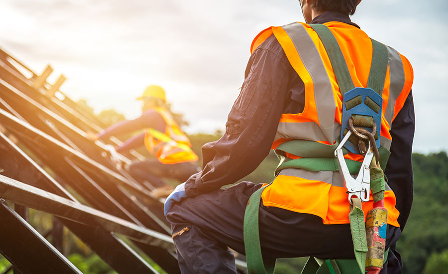 A construction worker on the roof of a building