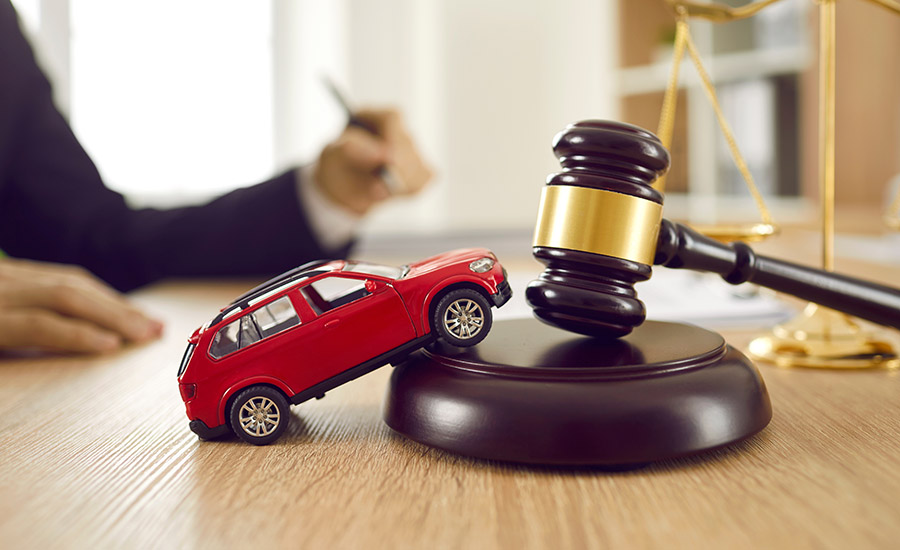 A gavel and a car toy on a lawyer's table