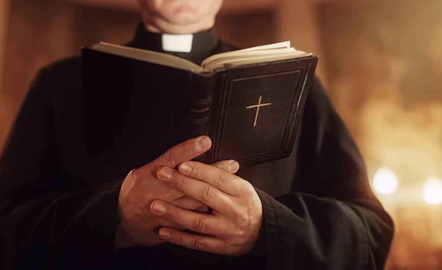 Close up of the Bible in the hands of a minister