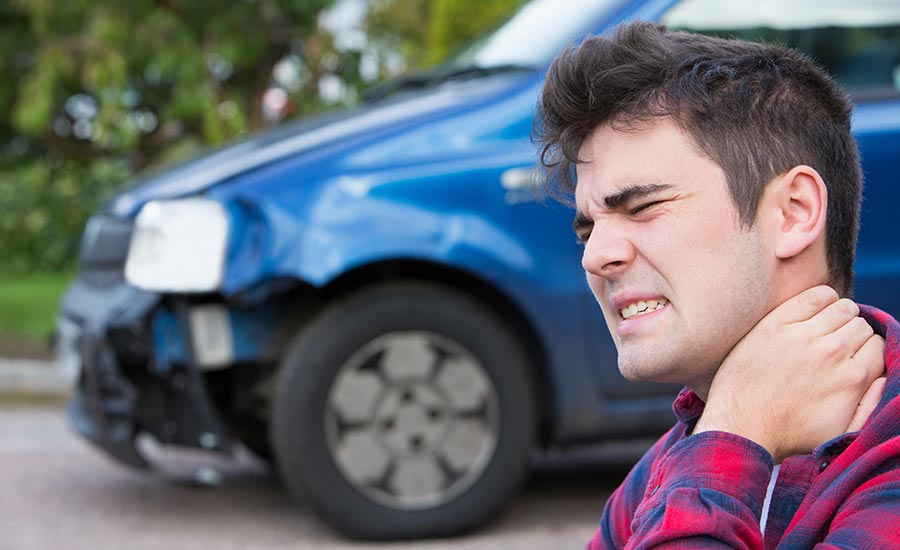 A man touching his neck after a collision