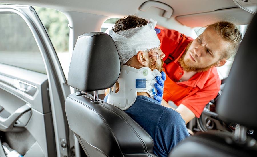 A man receives medical care after a car accident