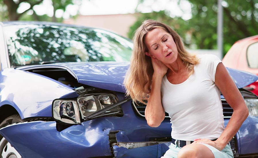 A woman experiencing neck pain after a car accident