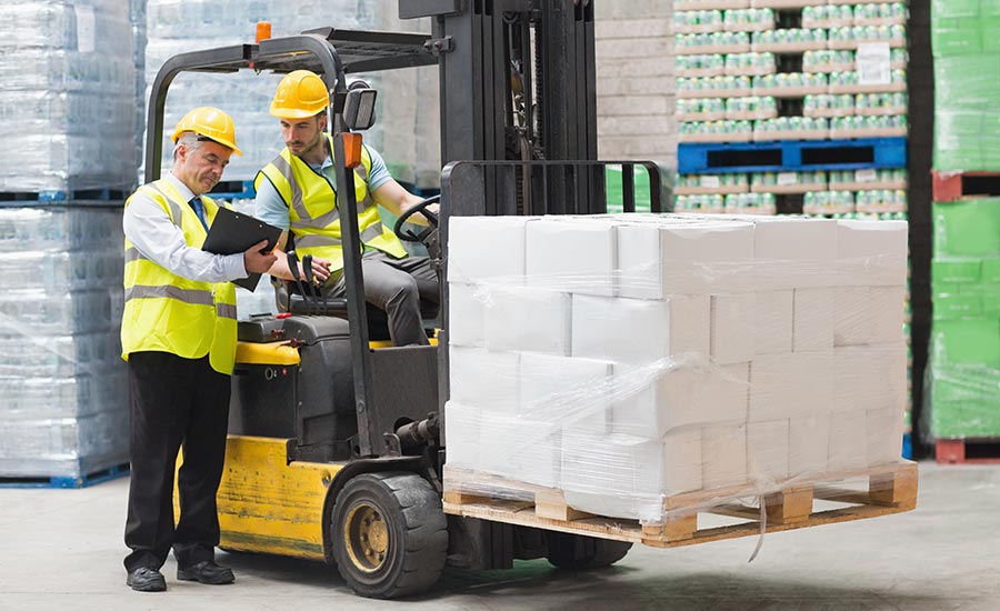 A forklift operator talking to his manager​