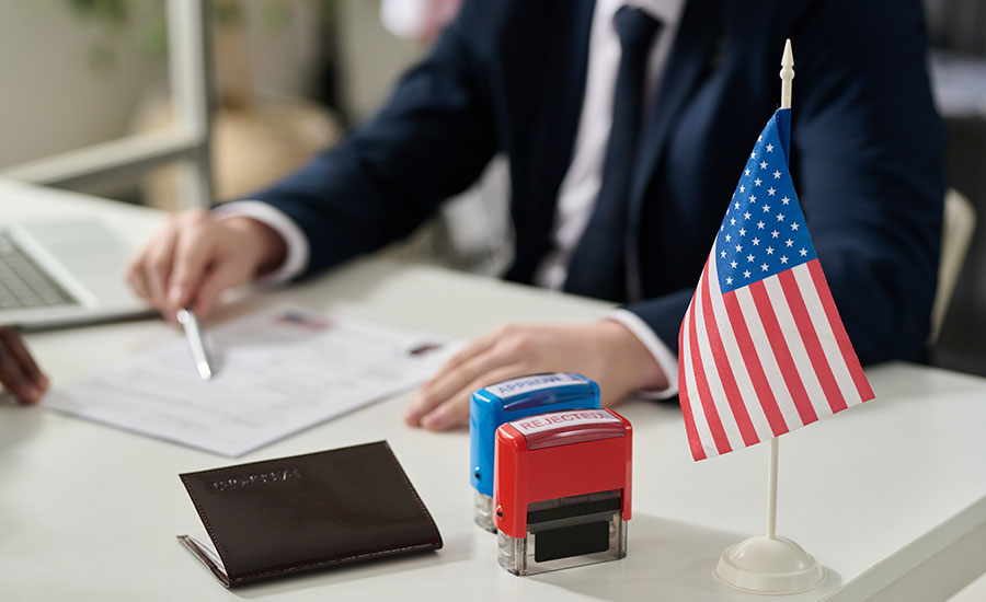 An immigration office employee with approved and rejected stamps on the table​