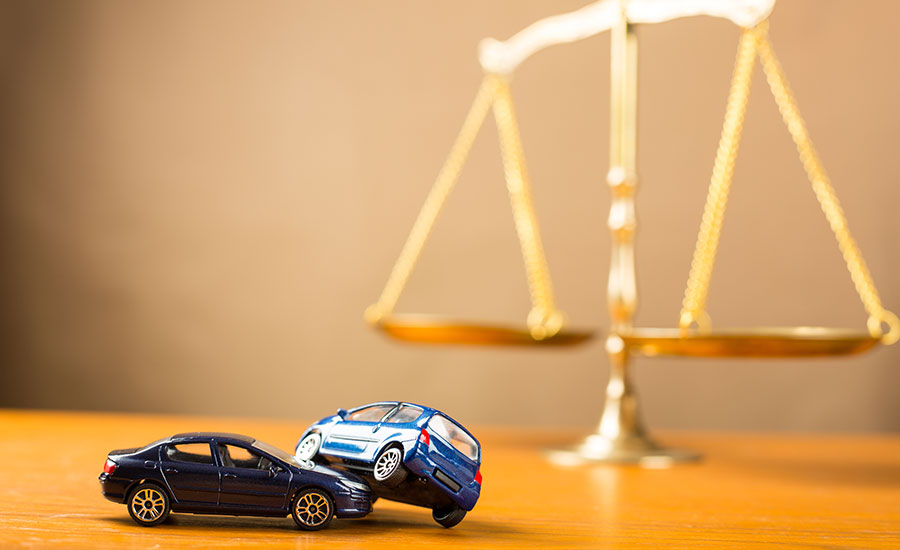 The scales of justice next to two toy cars​