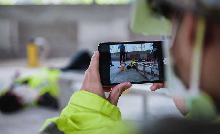 A worker record a construction accident on his smartphone​