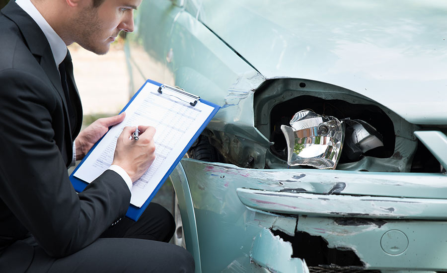 An employee from an insurance company completing a damage report​