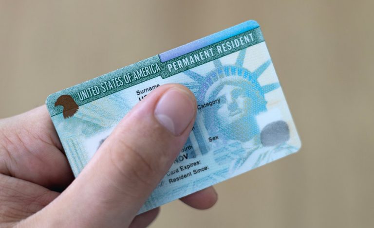 A person holding a Green Card